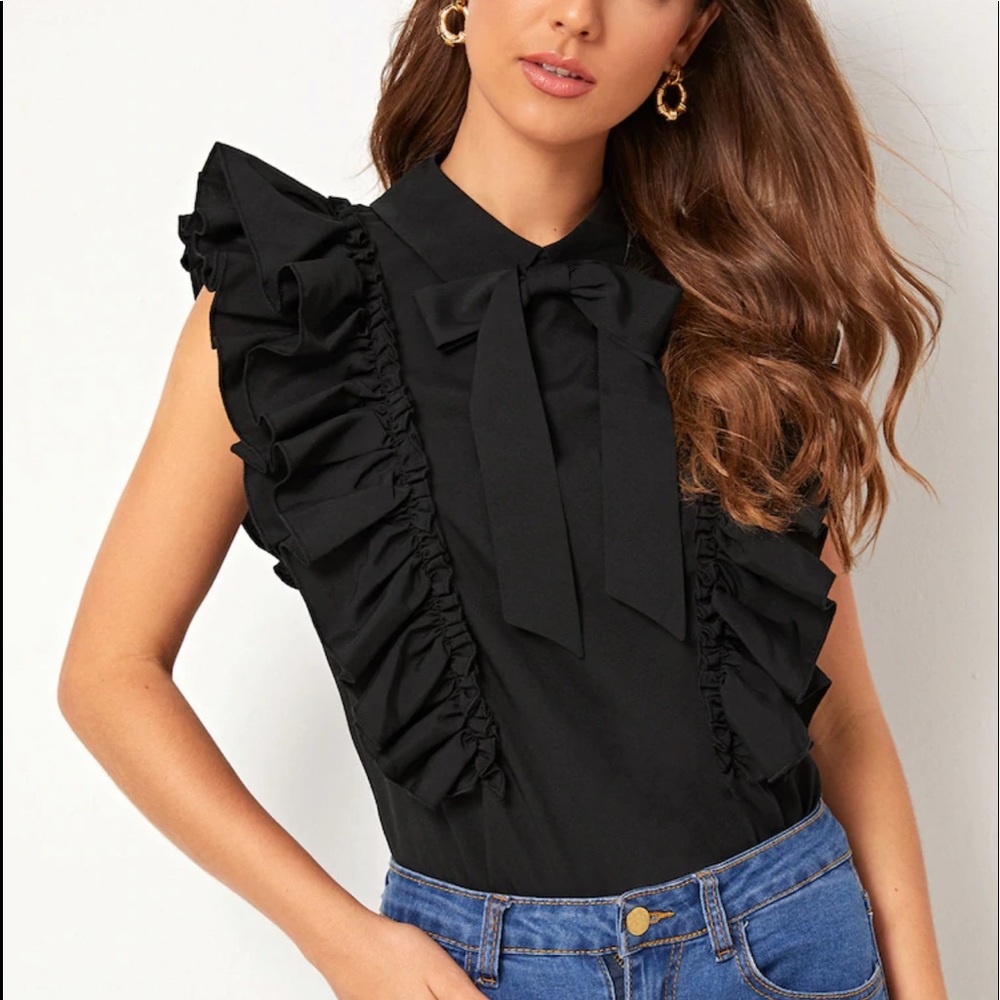 Black ruffled button up top.
